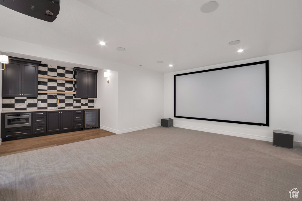 Carpeted home theater with wine cooler