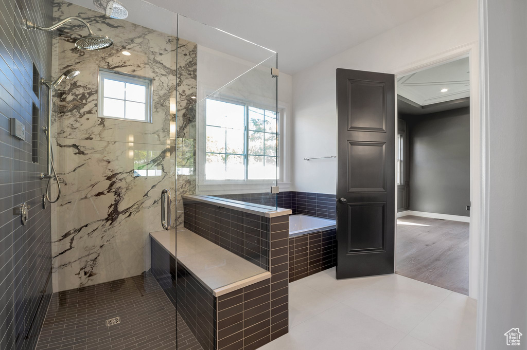 Bathroom with hardwood / wood-style flooring and separate shower and tub