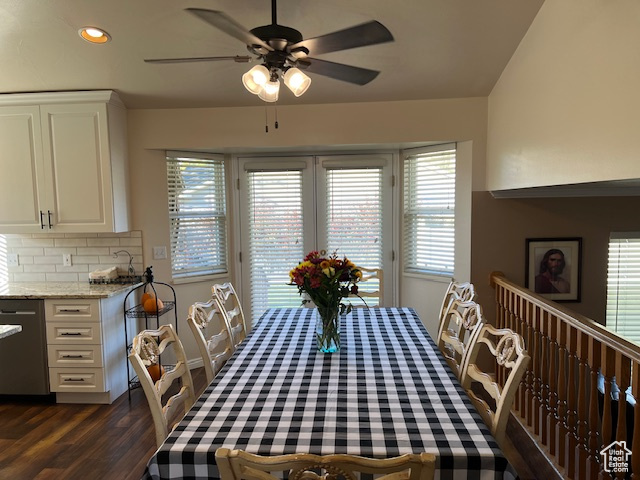 Dining space with dark hardwood / wood-style flooring, ceiling fan, and a wealth of natural light