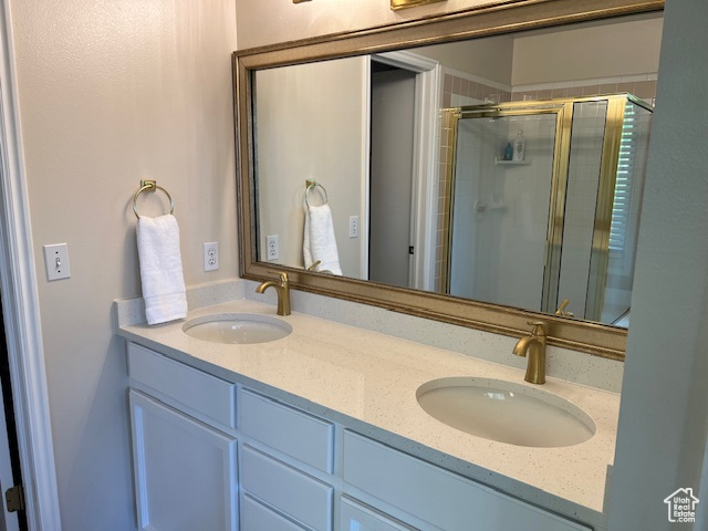 Bathroom featuring vanity and an enclosed shower