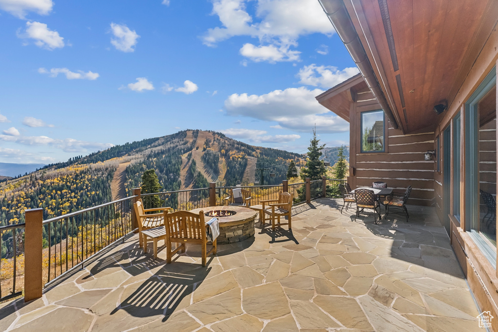 View of patio featuring an outdoor fire pit and a mountain view