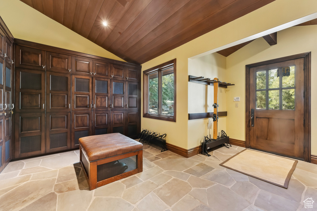 Foyer entrance with wood ceiling, a healthy amount of sunlight, and vaulted ceiling