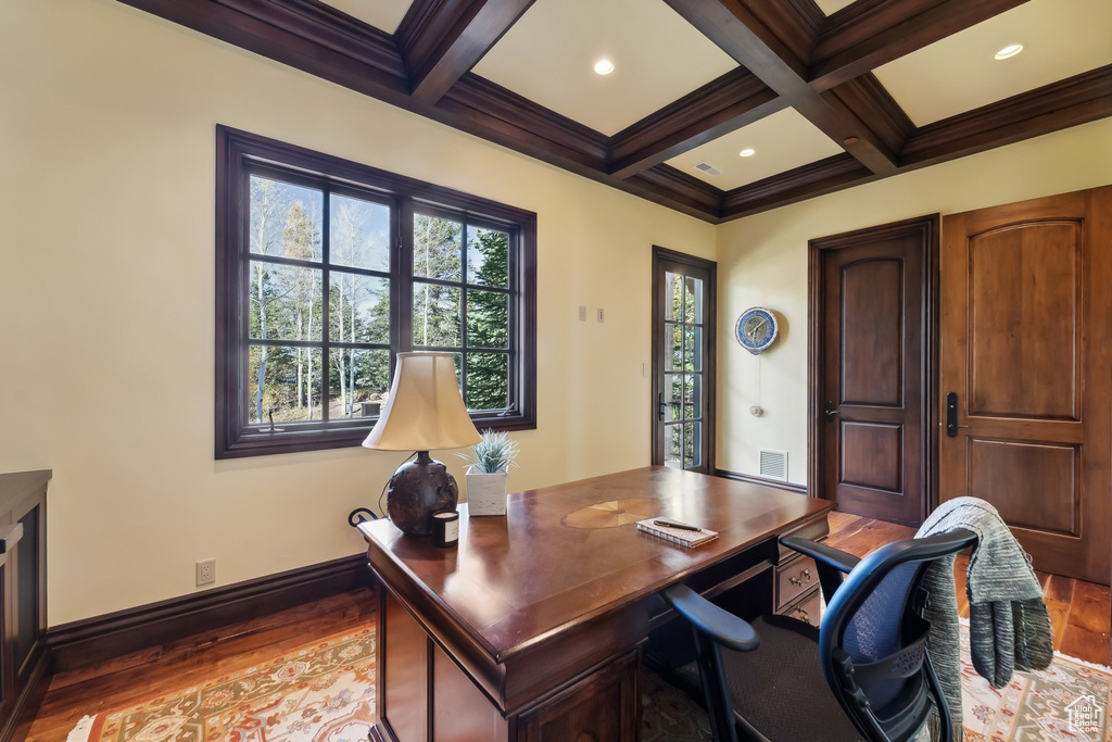 Office featuring coffered ceiling, beam ceiling, and hardwood / wood-style flooring