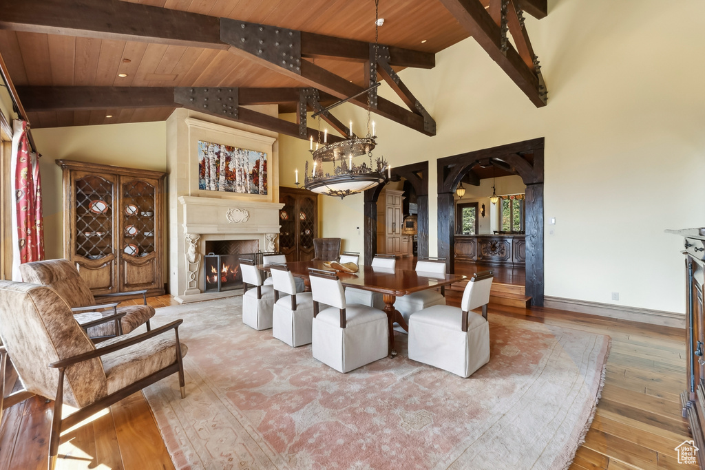 Living room with beam ceiling, high vaulted ceiling, wooden ceiling, and light wood-type flooring