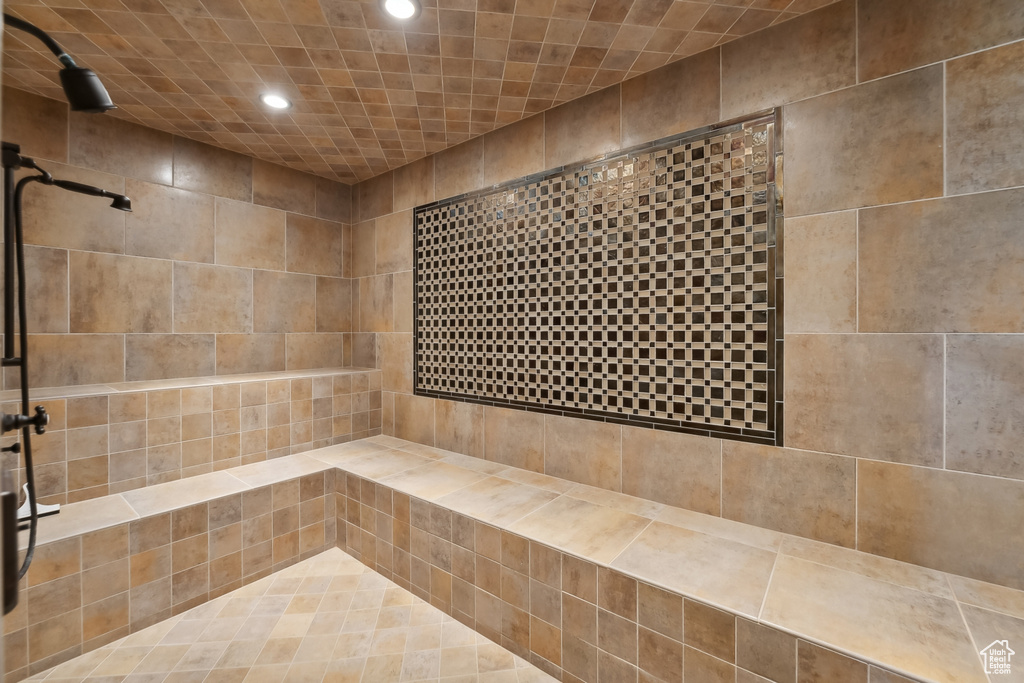 Bathroom featuring tile walls and tiled shower