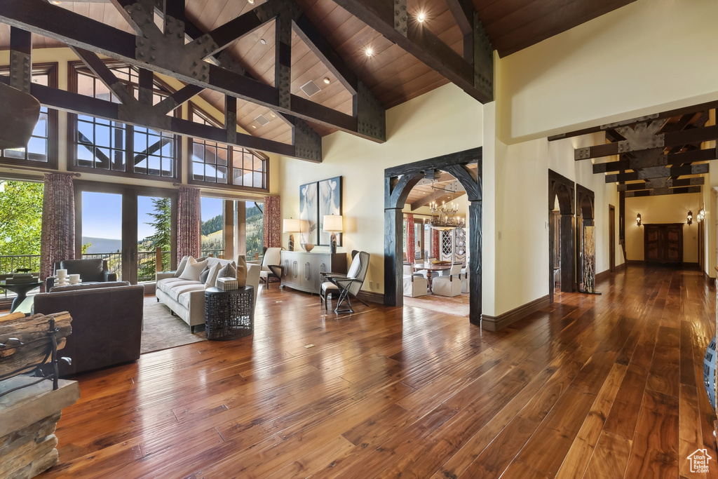 Living room featuring hardwood / wood-style floors, high vaulted ceiling, and plenty of natural light