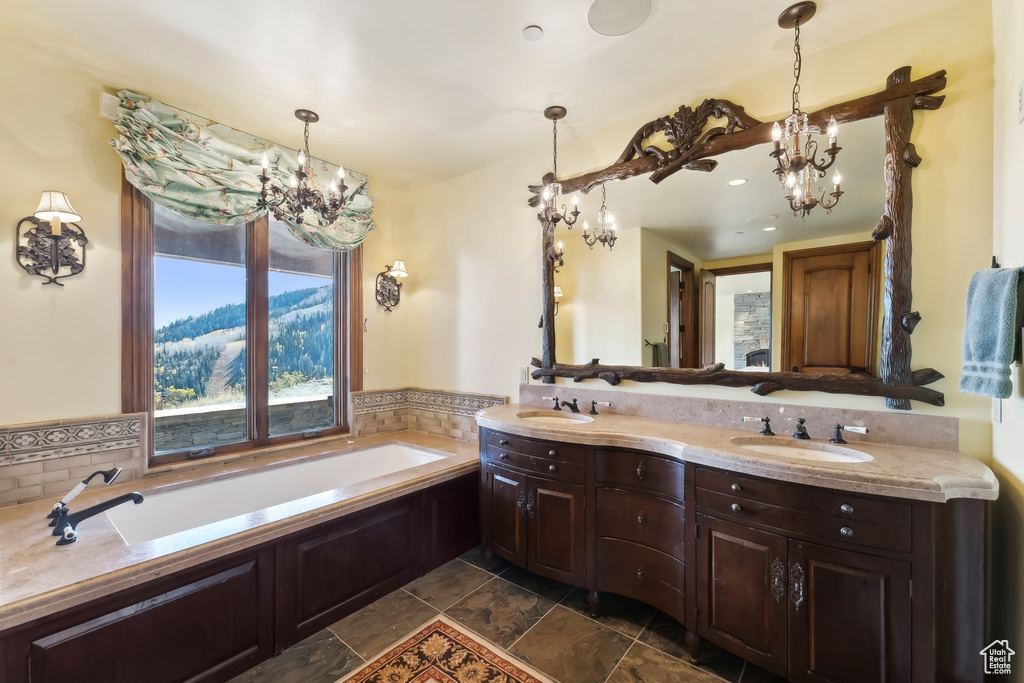 Bathroom featuring vanity, a tub, and tasteful backsplash