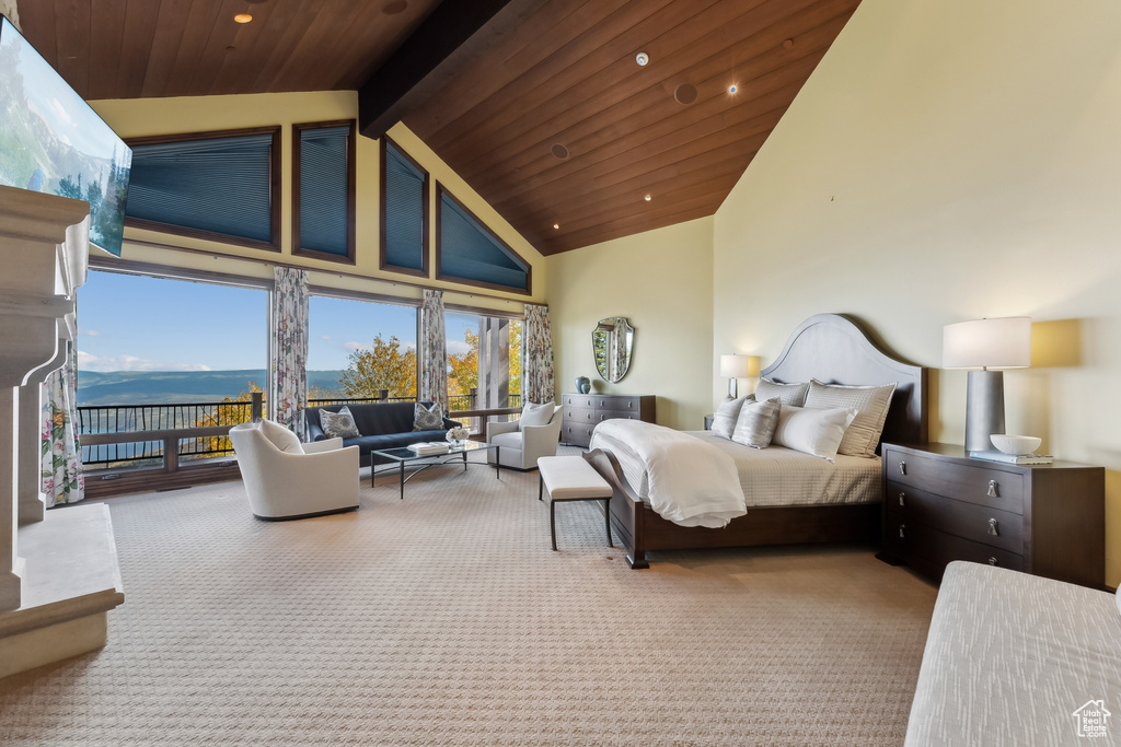 Carpeted bedroom featuring beam ceiling, high vaulted ceiling, and wood ceiling