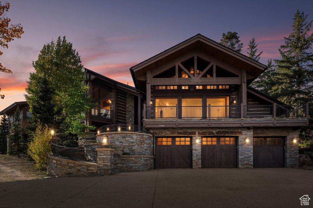 Craftsman-style house with a balcony and a garage