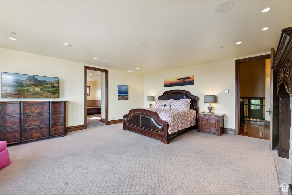 Carpeted bedroom featuring connected bathroom