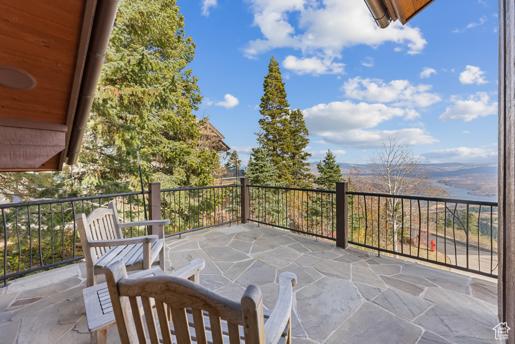 View of patio with a balcony and a mountain view