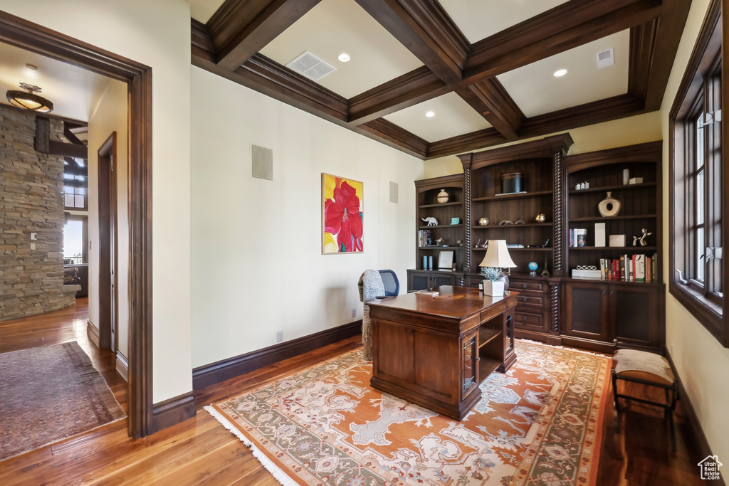 Office space featuring hardwood / wood-style flooring, beamed ceiling, coffered ceiling, and plenty of natural light