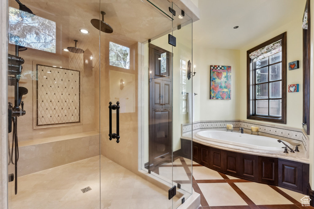 Bathroom with a healthy amount of sunlight and separate shower and tub