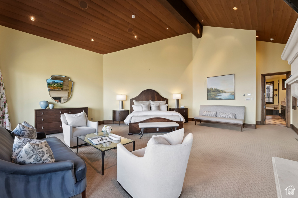 Bedroom featuring carpet floors, beamed ceiling, wooden ceiling, a fireplace, and high vaulted ceiling