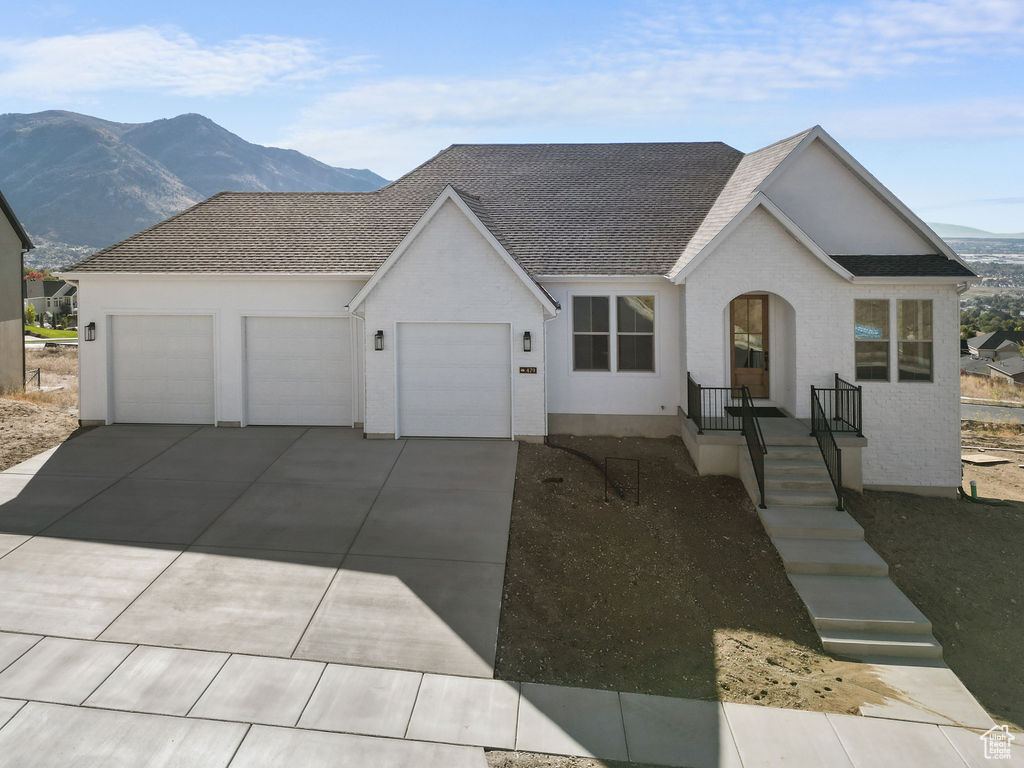 Ranch-style home featuring a mountain view and a garage