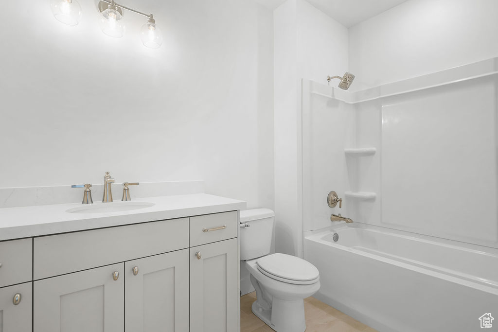 Full bathroom with toilet, shower / washtub combination, and vanity