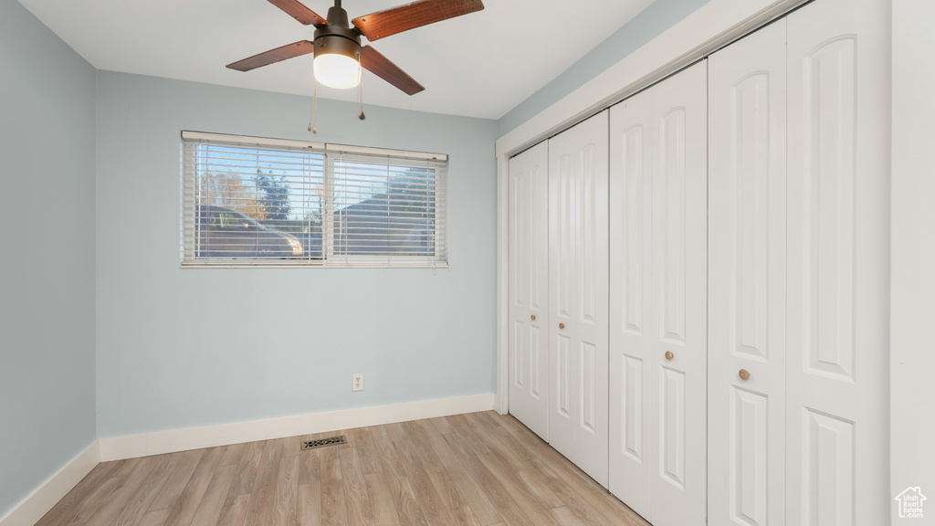 Unfurnished bedroom with light hardwood / wood-style floors and ceiling fan