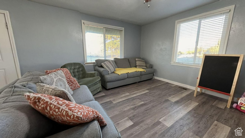 Living room featuring hardwood / wood-style flooring and ceiling fan