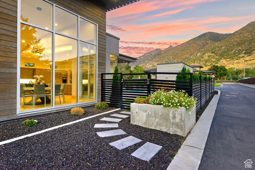 Property exterior at dusk featuring a mountain view