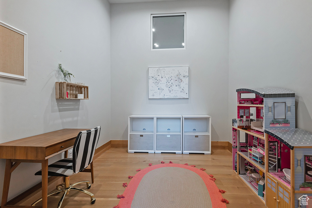 Home office with light hardwood / wood-style floors