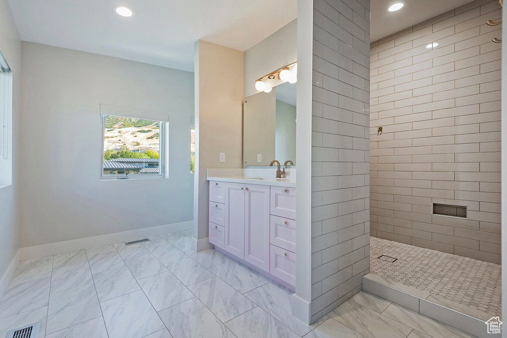 Bathroom with vanity and a tile shower