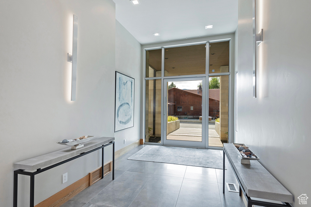 Entryway featuring concrete floors and floor to ceiling windows