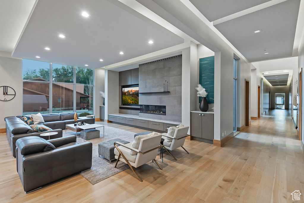 Living room featuring light hardwood / wood-style flooring and a tile fireplace