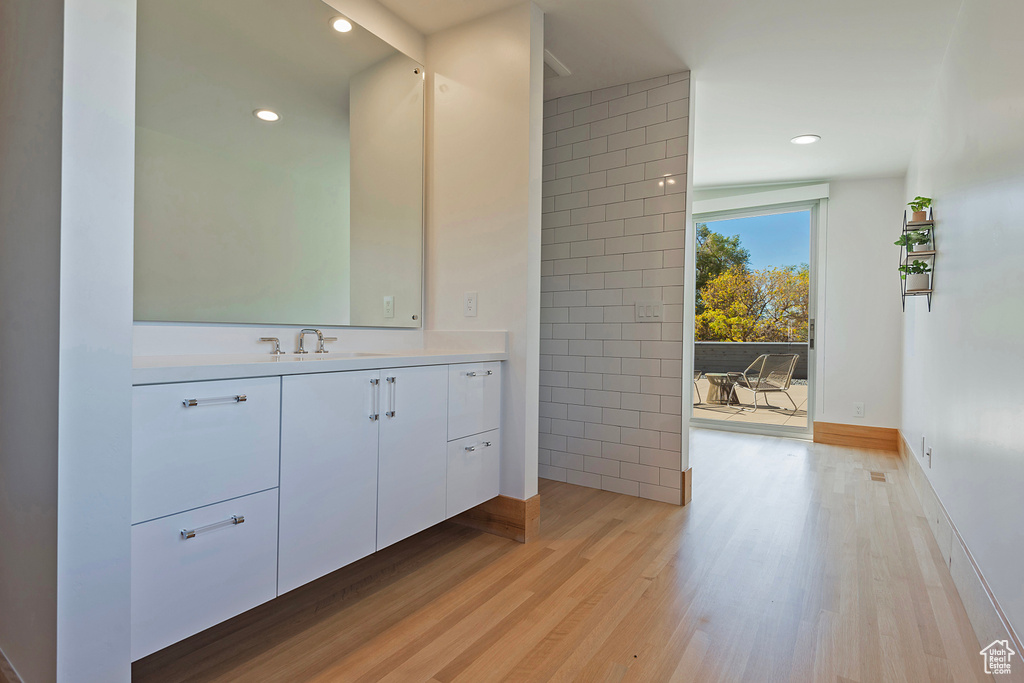 Bathroom featuring vanity and wood-type flooring