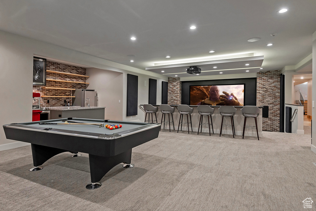 Playroom featuring light carpet, bar, and billiards