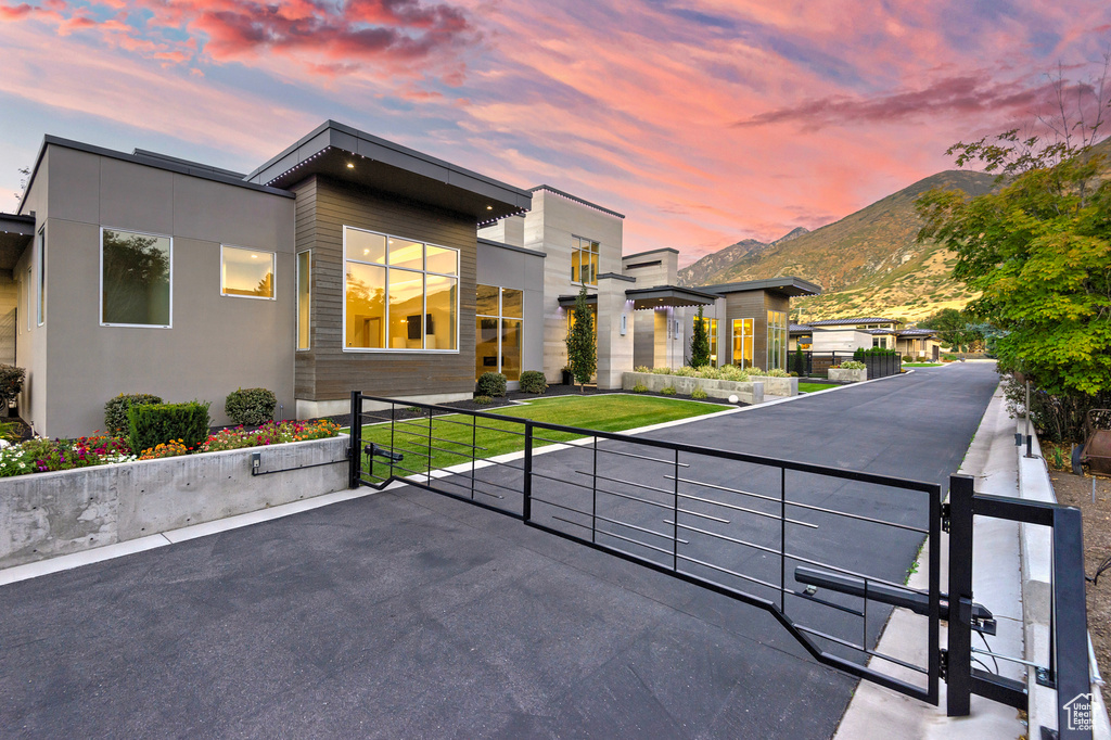 View of front facade featuring a mountain view and a lawn