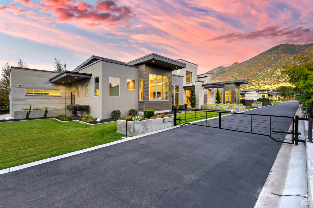 Modern home with a mountain view, a yard, and a balcony