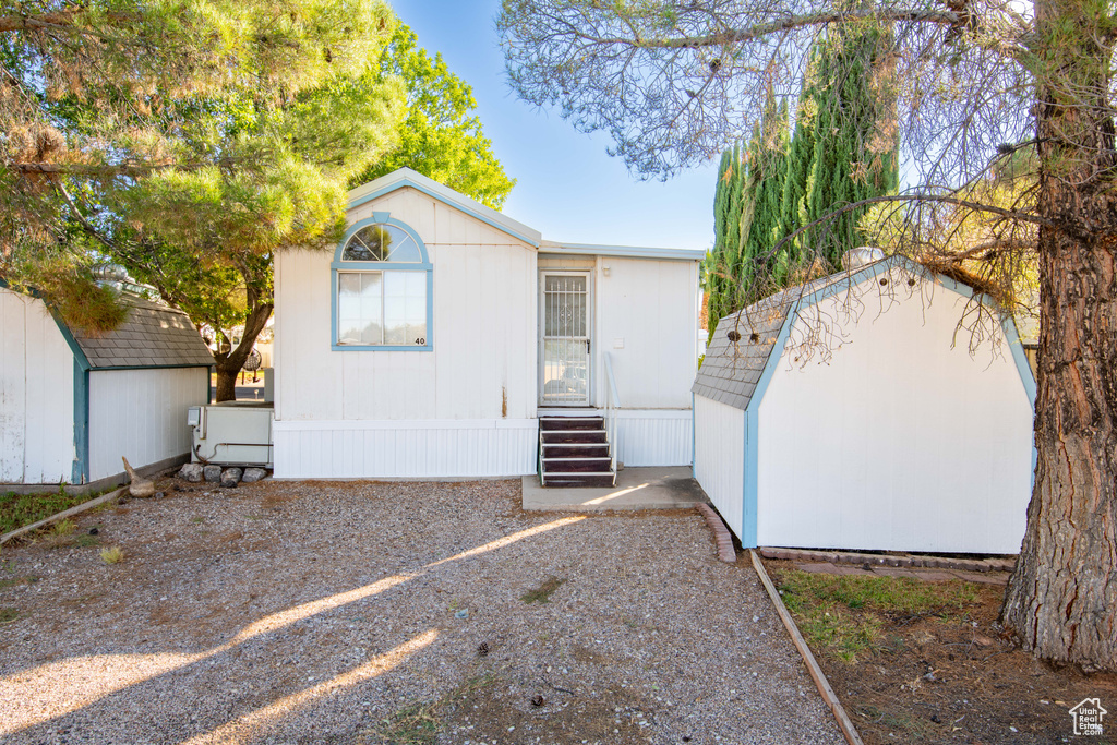 View of front facade with a storage shed