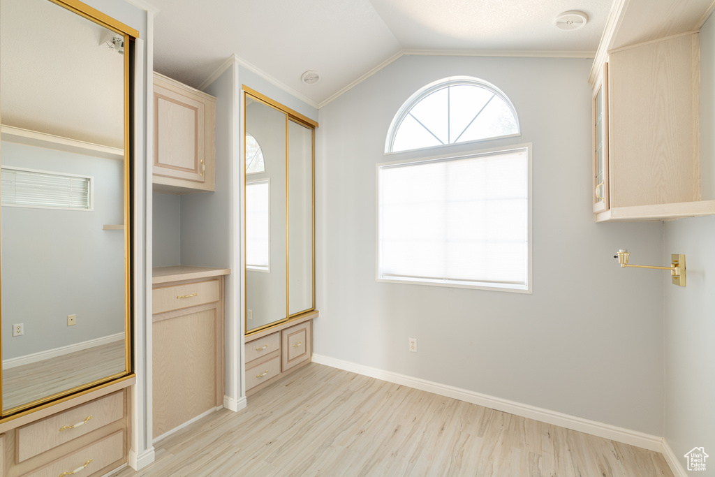 Interior space with crown molding and light hardwood / wood-style floors