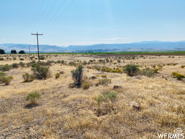 Property view of mountains with a rural view