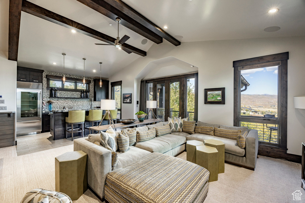Living area with wet bar, recessed lighting, light colored carpet, and a ceiling fan