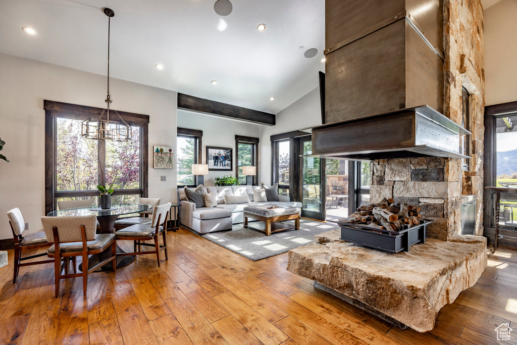 Living room featuring hardwood / wood-style flooring, high vaulted ceiling, and recessed lighting