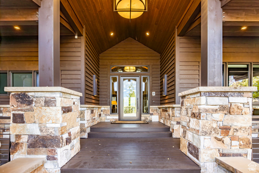 Property entrance featuring stone siding and a porch