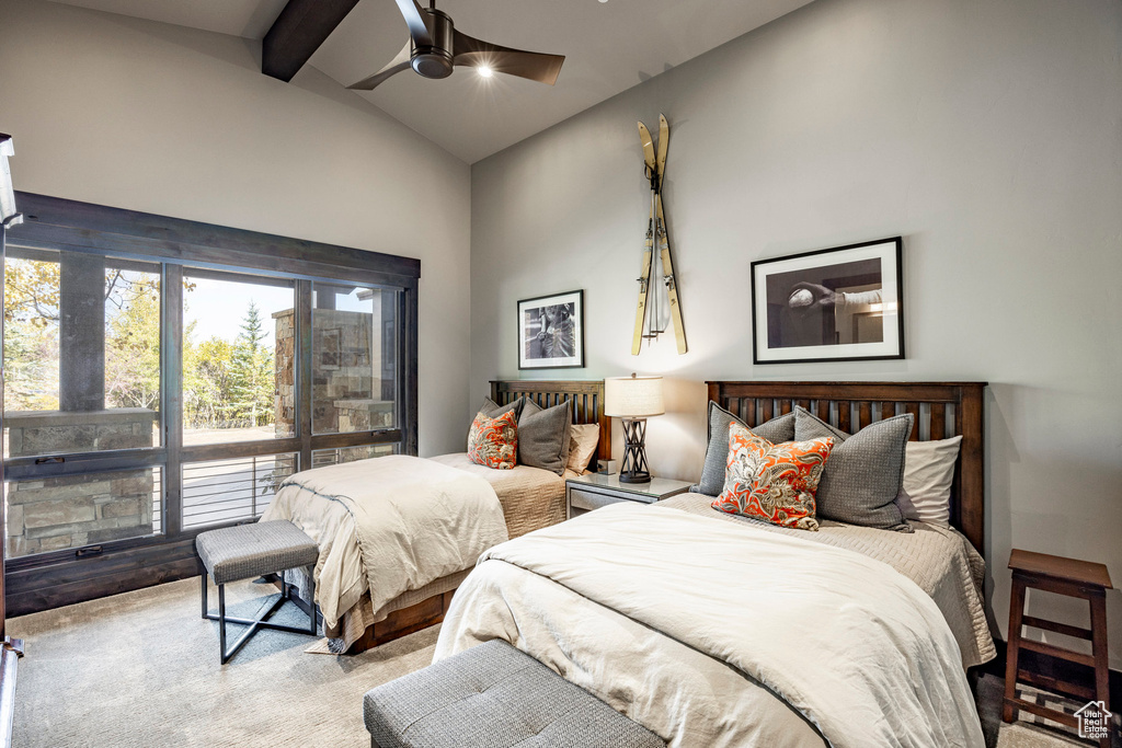 Carpeted bedroom with beamed ceiling, high vaulted ceiling, and ceiling fan