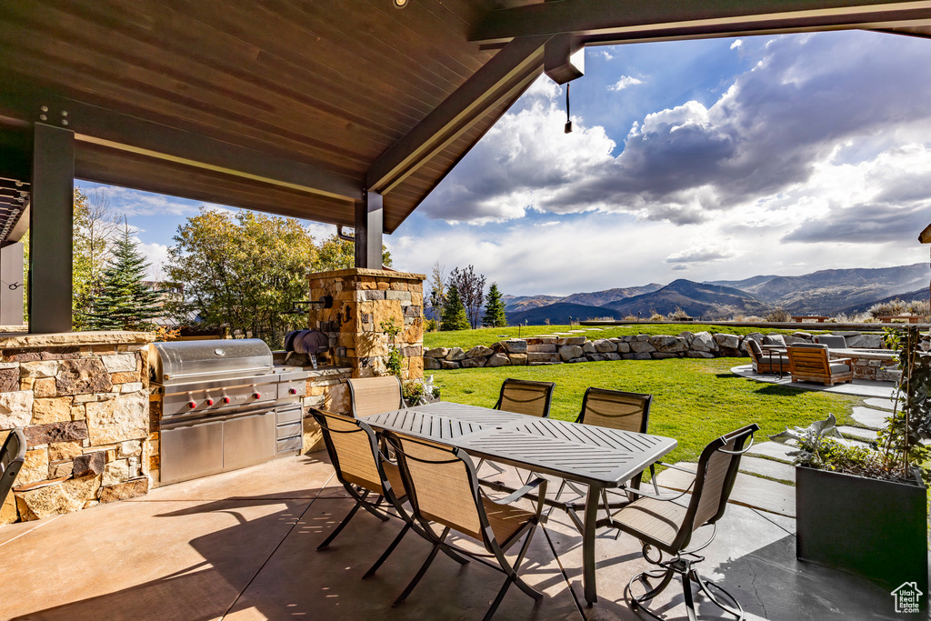 View of patio / terrace featuring outdoor dining area, a mountain view, and outdoor lounge area