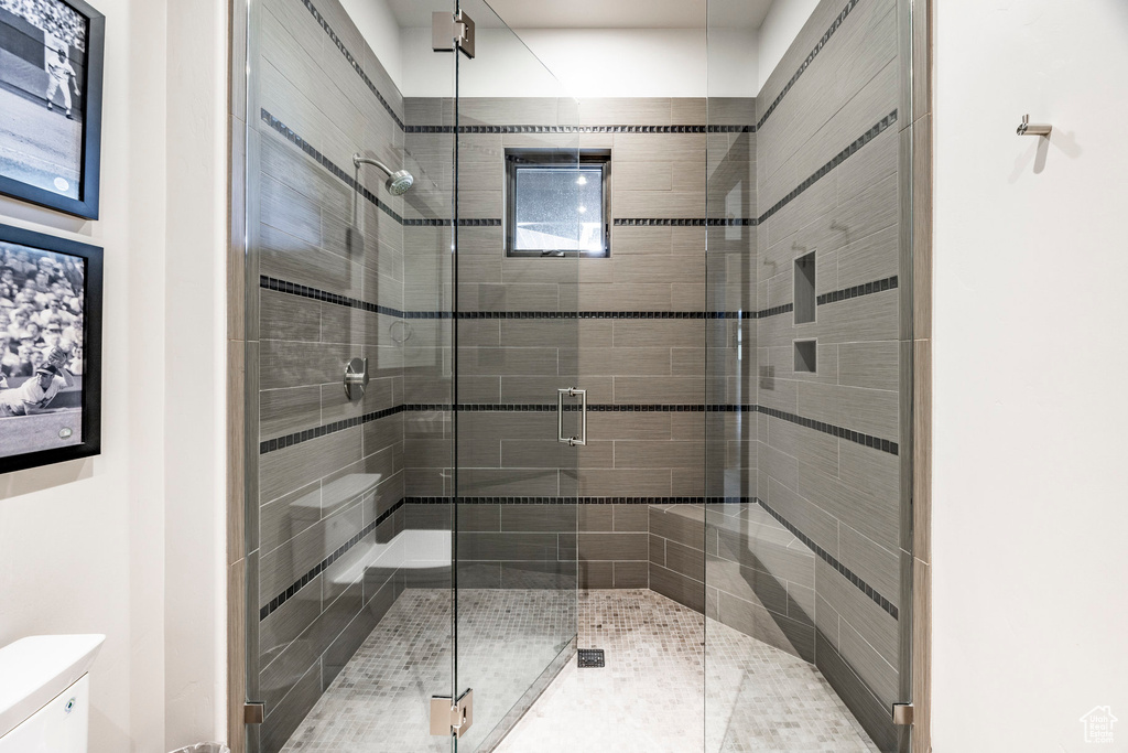 Bathroom featuring toilet and a shower stall