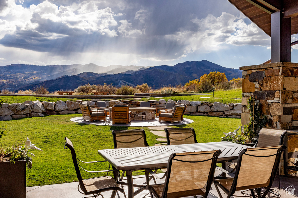 View of patio / terrace with a mountain view and outdoor dining area