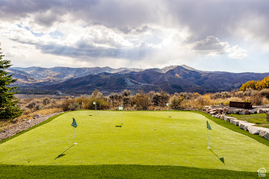 View of community featuring a mountain view and an area to practice putting