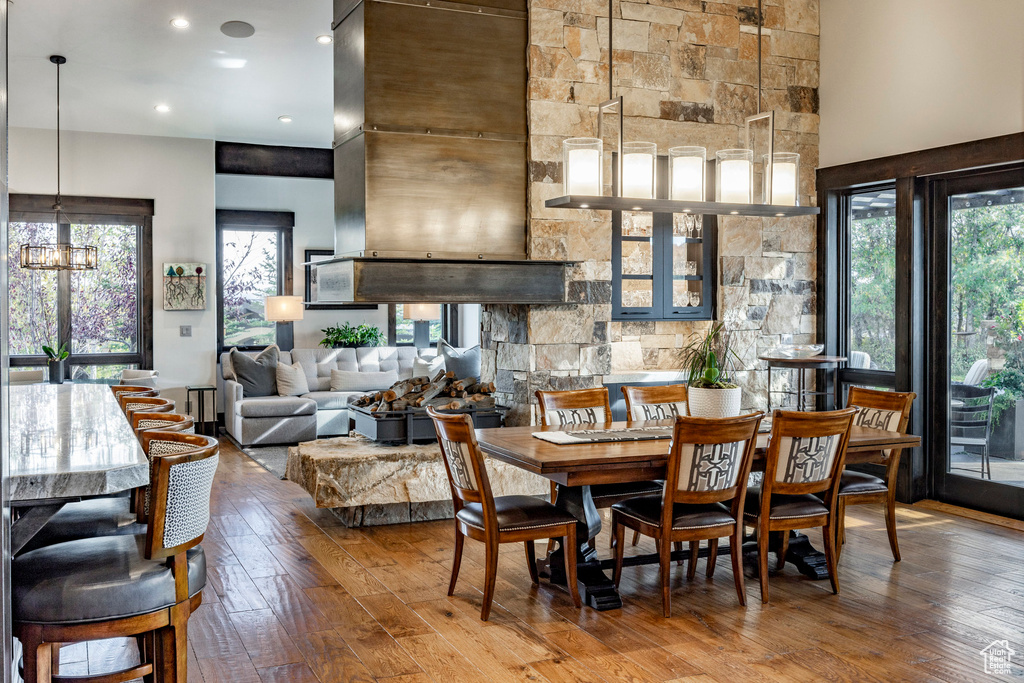 Dining area with hardwood / wood-style flooring, a chandelier, and recessed lighting