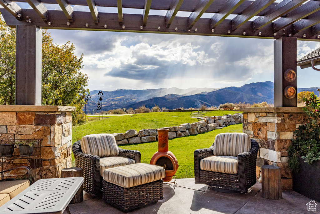 View of patio with a mountain view and a pergola