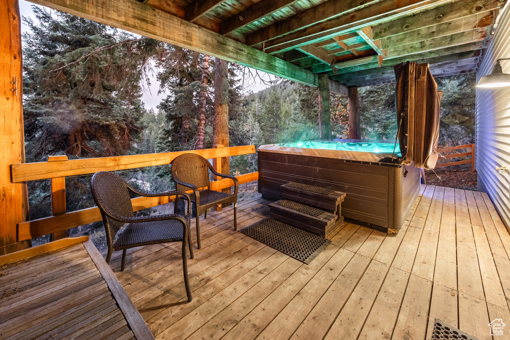 Wooden terrace featuring a hot tub