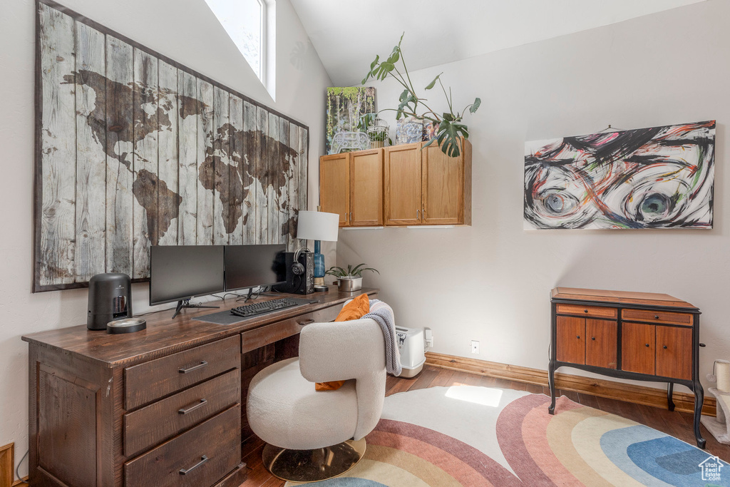 Office featuring wood finished floors and vaulted ceiling