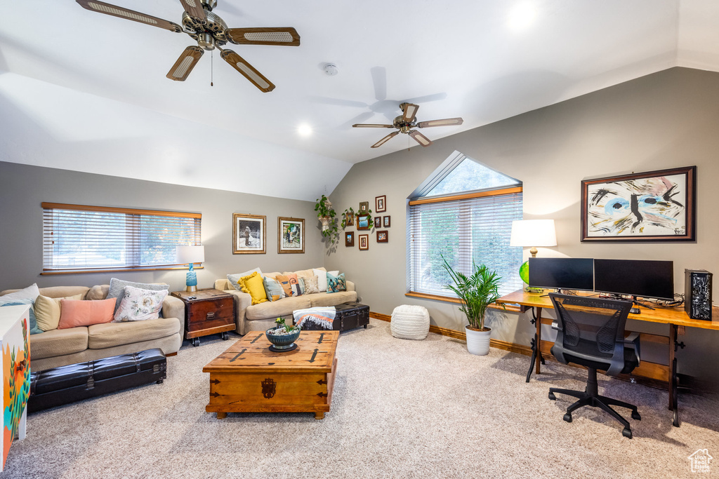 Living room featuring a healthy amount of sunlight, carpet, and lofted ceiling
