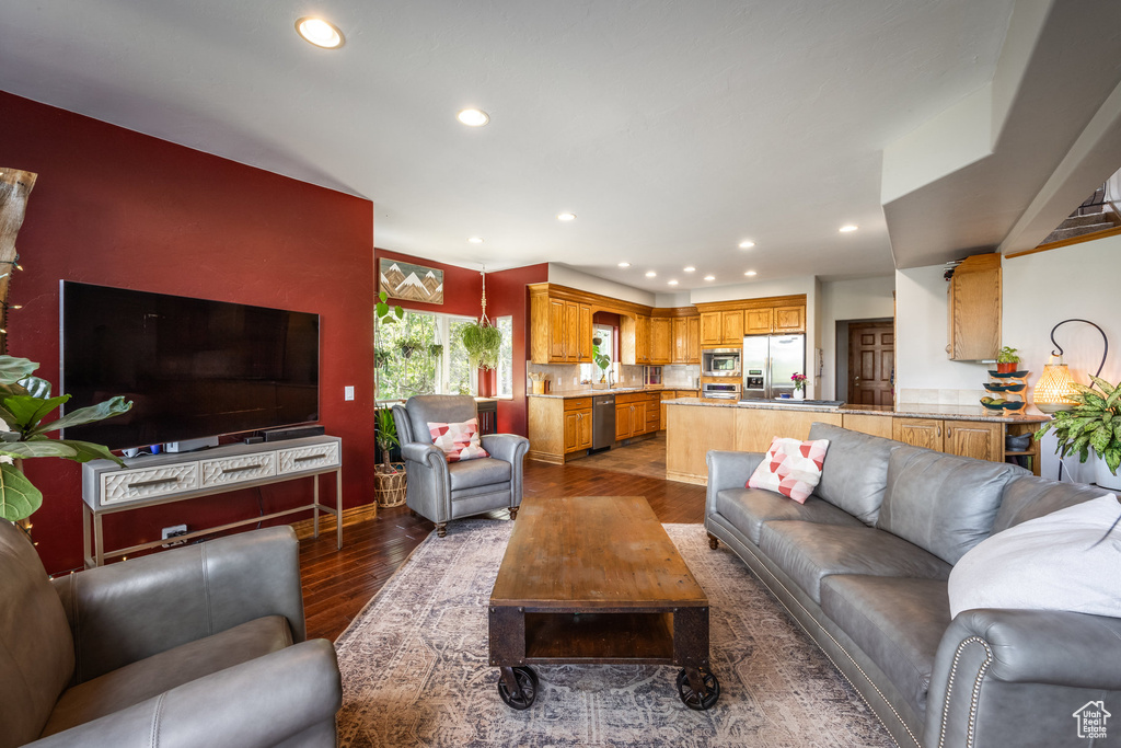 Living room featuring dark wood-style floors and recessed lighting