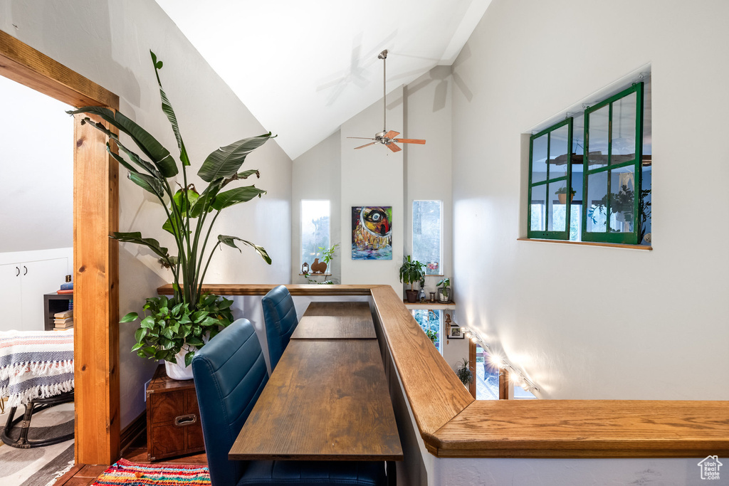 Dining area with high vaulted ceiling and ceiling fan