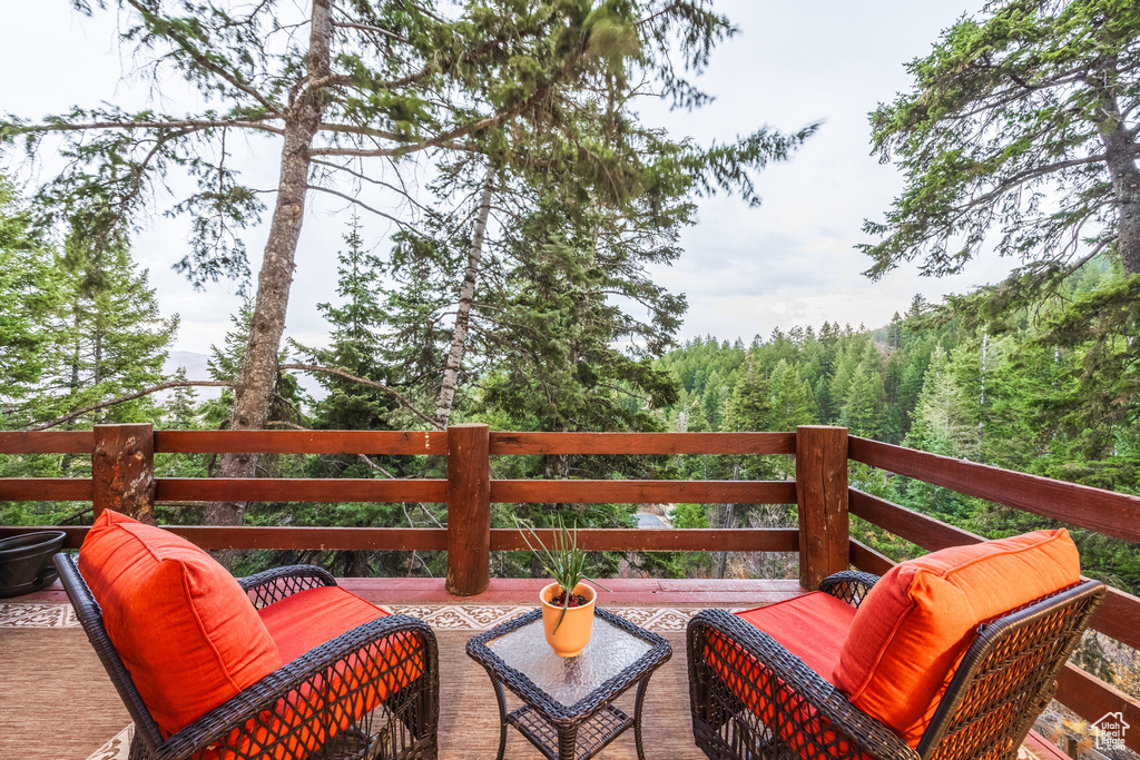 Deck featuring a wooded view